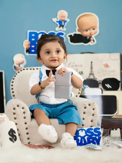 Holding a prop phone, this Boss Baby is making important calls. Interactive props make the session fun for the baby.