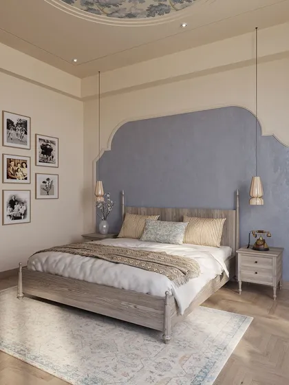 This bedroom design evokes a sense of nostalgia and classical charm. A textured blue accent wall creates a focal point behind the traditional wooden bed, while a gallery wall of family photos makes the space deeply personal.