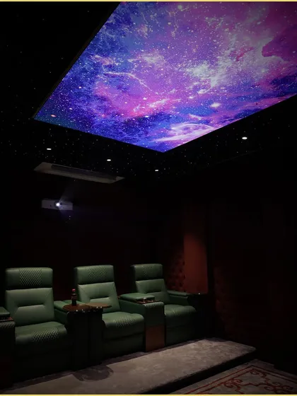 Another angle of our custom home theater, highlighting the dramatic effect of the fiber optic and printed galaxy ceiling. This feature adds a unique visual dimension, making movie nights truly magical.