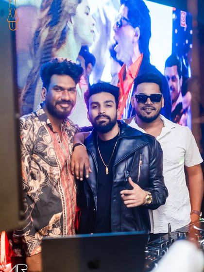 Taking a moment for a photo with the crew behind the DJ booth. It takes a team to put on a great night.