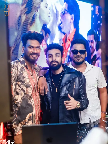 Taking a moment for a photo with the crew behind the DJ booth. It takes a team to put on a great night.