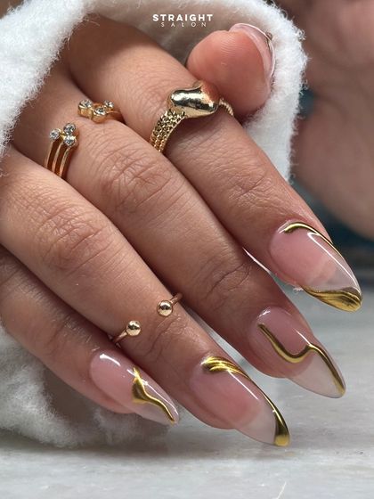 A different angle of the abstract gold nail art, showing how the light plays off the raised metallic details. This is a perfect example of minimalist design with a maximalist impact.