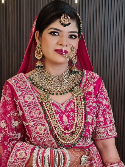 Another angle of this gorgeous bride. The multiple layers of her necklace, combining pearls and green stones, add so much depth to her look.