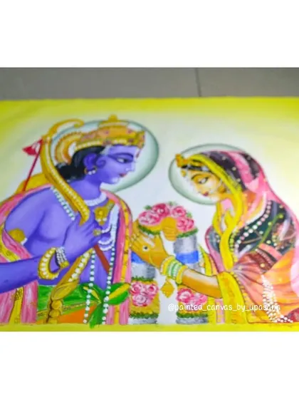 A slightly different angle of the completed Ram and Sita painting, showcasing the vibrant yellow background that makes the figures pop.