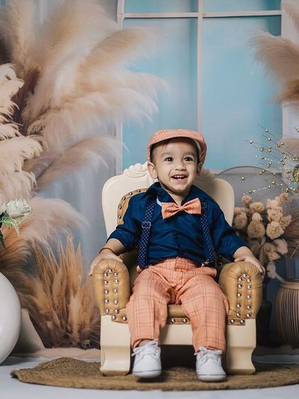 I’m not just growing up, I’m growing awesome! A happy boy in a dapper outfit enjoys his time in our boho-chic studio.