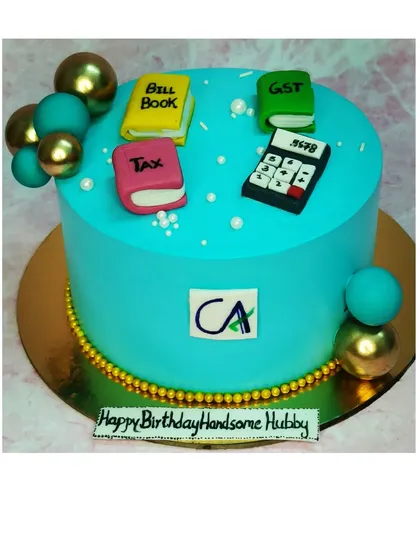 A cake for a Chartered Accountant, decorated with fondant tax books and a calculator. This is a chocolate roasted almond flavor.
