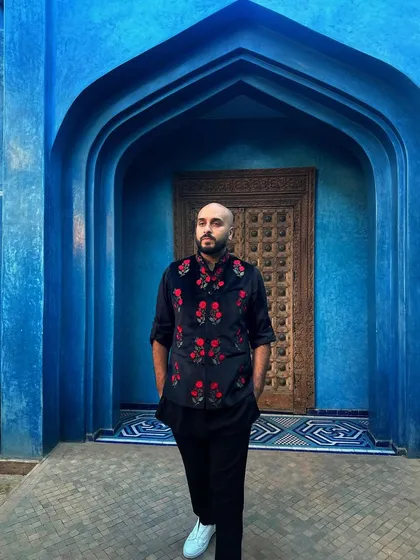 A closer look at my floral embroidered vest against the Moroccan blue. My outfits are always chosen to complement the event's theme and location.