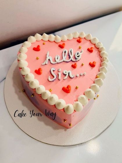 A minimalist heart-shaped bento cake that says "Hello Sir."
