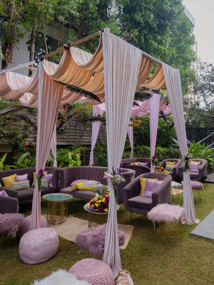 Another angle of the backyard Haldi and Mehendi setup, showing the comfortable and stylish lounge areas we created under the canopies.