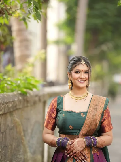 I have experience with a variety of traditional styles, including this classic South Indian look. The makeup features defined eyes and a radiant base, complemented by a traditional hairstyle and attire for a culturally rich wedding ceremony.