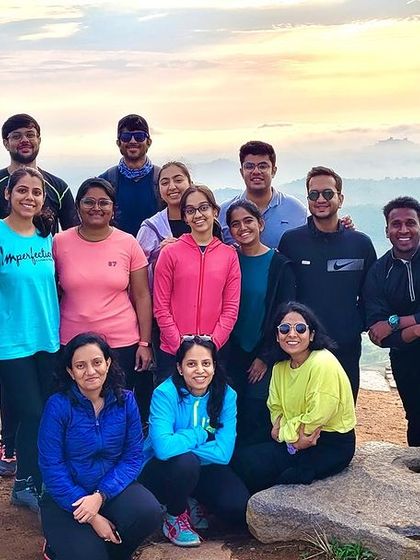 A group photo during a sunrise trek. The golden light and misty background make for a beautiful memory.