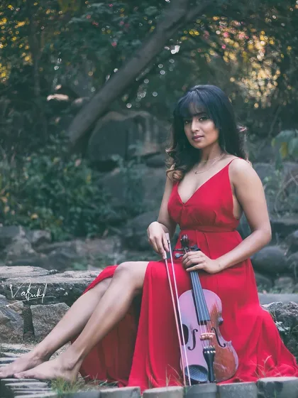 A picture painted in a dream and captured through the camera. This conceptual shoot combines the elegance of a flowing red dress and a violin with a rustic, natural setting for a truly artistic portrait.
