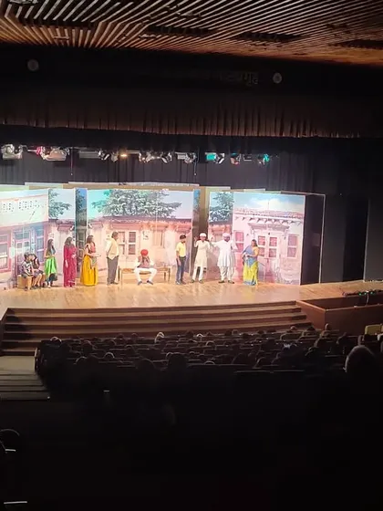 A wide shot of the stage and audience during the "AAVJE" drama performance. The set design and lighting were fantastic.