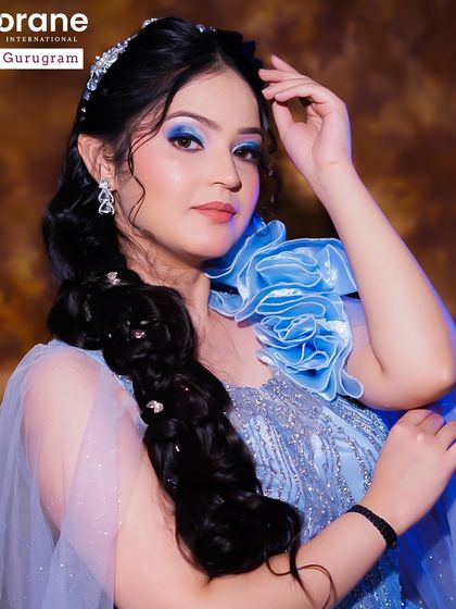 A fantasy inspired look with bold blue eyeshadow and a creative braid. This shows the artistic freedom I encourage in my students to develop their unique style.