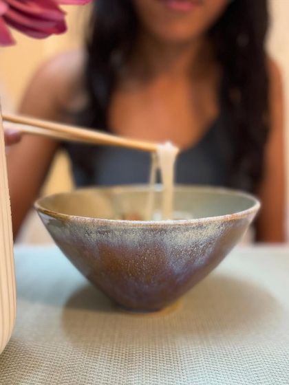 A quiet moment enjoying a meal from our new Rutile glaze bowl. The subtle, iridescent colors of the glaze are just beautiful.