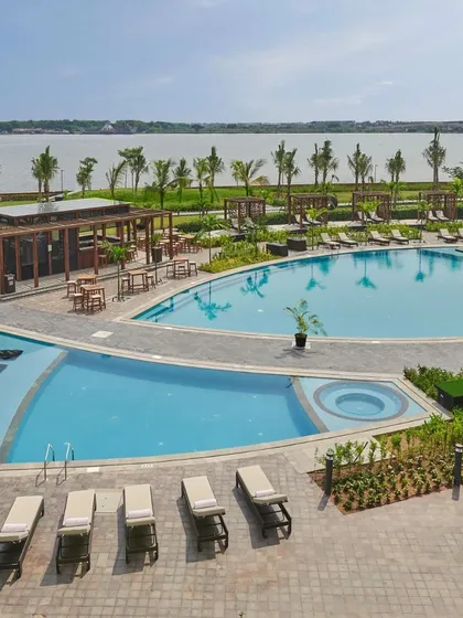 The stunning pool and backwaters view at Grand Hyatt Kochi. This venue offers a unique blend of resort luxury and natural beauty.
