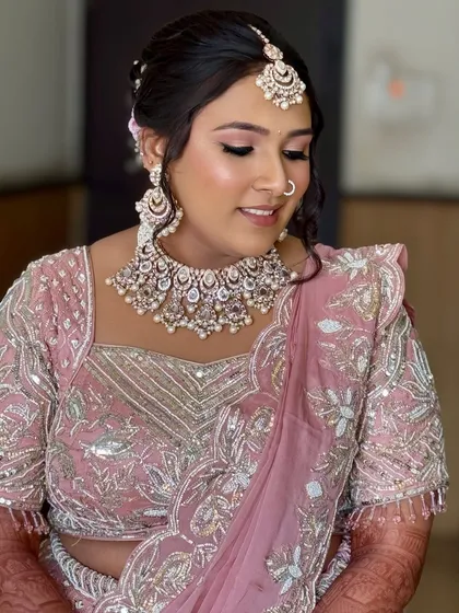 A beautiful shot showing the details of the makeup and jewelry. The soft pink tones on the eyes and lips tie the whole look together.