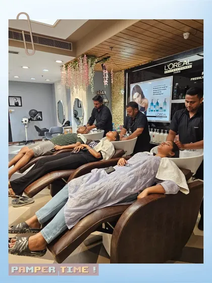 A glimpse into the relaxing experience at our salon. Clients are seen unwinding at our comfortable hair wash stations, receiving a gentle scalp massage and hair spa treatment from our professional staff.