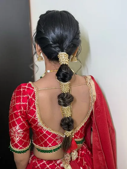 A view of the stunning traditional hairstyle for the Mata Ki Chowki. The intricate braid is adorned with beautiful gold accessories.