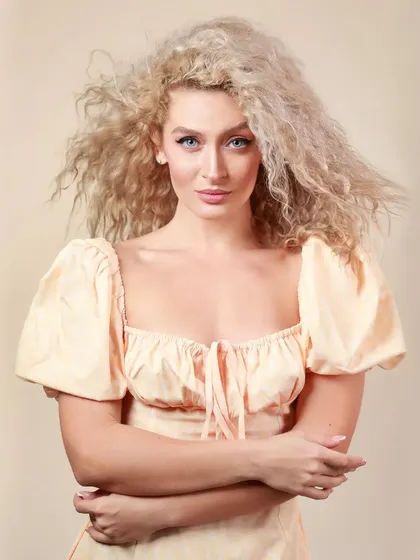 A high-key headshot of the same model against a light background, showing versatility.