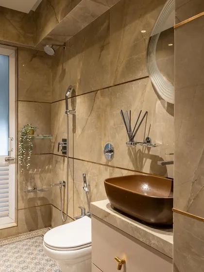 A full view of the bathroom with the brown vessel sink, showing the patterned floor tiles that add another layer of detail and contrast to the space.