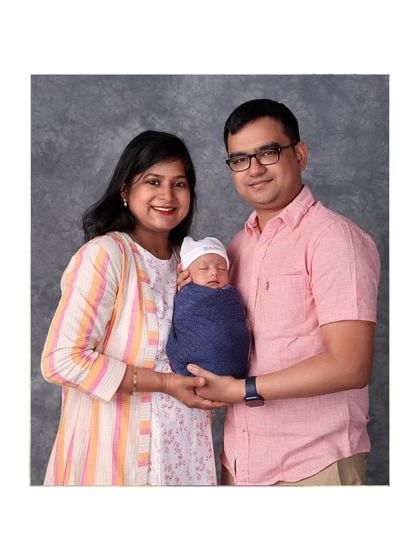 A classic portrait of a new family of three. They look so happy and complete.