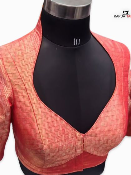 A brocade blouse with a deep V-neck and collar. If you are a textile retailer, I can manufacture this or any other design for your brand.