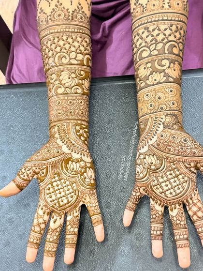 A top-down view that emphasizes the detailed work on the palms and forearms, featuring a mix of floral and geometric patterns.