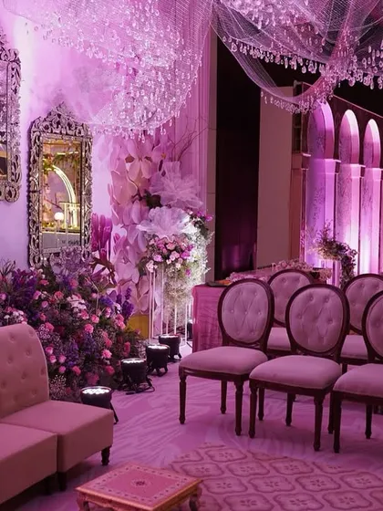 Another view of the lilac dreamscape, showing the central loveseat nestled in a bed of purple and pink flowers, creating a perfect photo opportunity for the couple.