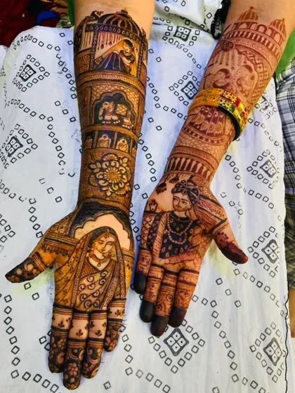 A stunning bridal mehendi featuring portraits of a Maharashtrian bride and groom. The design also includes traditional elements like the doli and kalash, making it a complete wedding story.