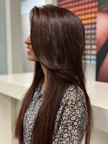 A beautiful cherry brown hair color. This shade is the perfect blend of rich brown with a hint of red, giving the hair a warm, vibrant glow that catches the light beautifully.