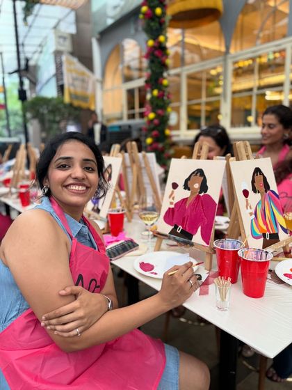 A smiling participant at a private paint party, enjoying the creative process. My workshops are designed to be fun and accessible for everyone, regardless of their artistic skill.