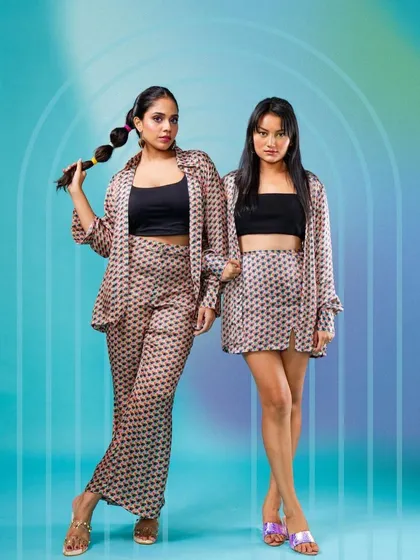 A modern duo shot for Raki Designs, featuring clean makeup and a trendy bubble ponytail hairstyle.