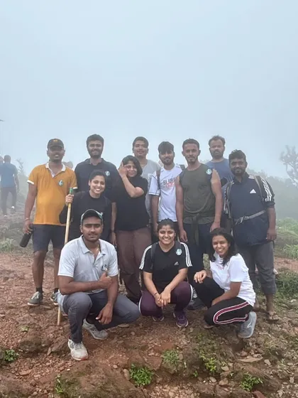 A small group photo in the misty weather at a mountain peak. Even with fog, the sense of accomplishment is crystal clear.