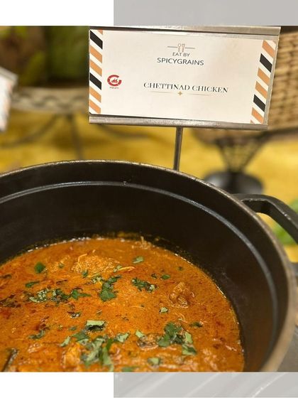 A steaming pot of Chettinad Chicken, a spicy and aromatic curry from South India, ready to be served.