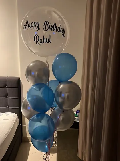 A simple and stylish birthday bouquet for Rahul. This arrangement includes a personalized clear bubble balloon paired with classic blue and silver balloons, perfect for a surprise at home.