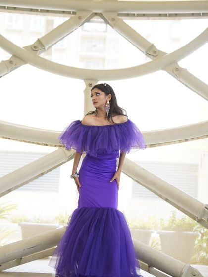 Another perspective of the purple gown look, showing how the makeup looks against a bright, airy background. The clean lines and fresh skin are versatile for any commercial setting.
