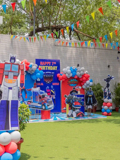 A wide shot of the superhero-themed party setup on our lush green lawn. We can transform our outdoor space to fit any theme, big or small.