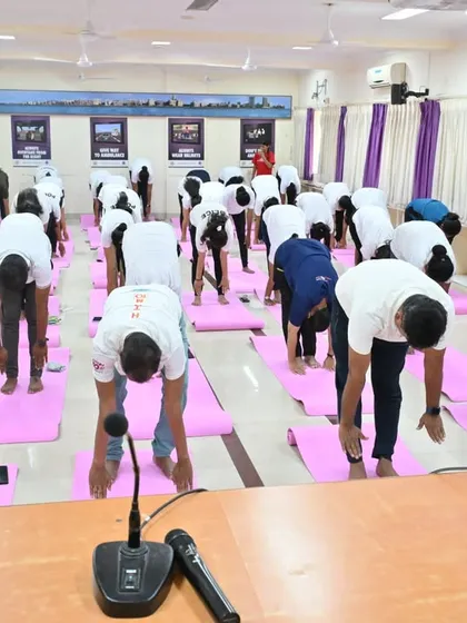 Mumbai Traffic Police practicing Padahastasana (Hand to Foot Pose). This forward bend helps to calm the brain and relieve stress and mild depression.