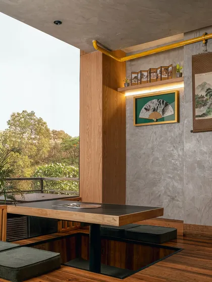Another perspective of the sunken seating, showing how the space is designed for comfort and intimacy. The low table and floor cushions create a relaxed atmosphere, perfect for long conversations over a shared meal.