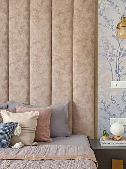 This bedroom from our Zen Residence project features a plush, channel-tufted headboard paired with delicate floral wallpaper. The combination of textures and soft colors creates a contemporary yet serene environment.