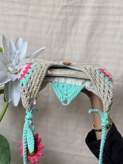 This view shows how the bag opens, revealing the inner lining and the secure button closure.