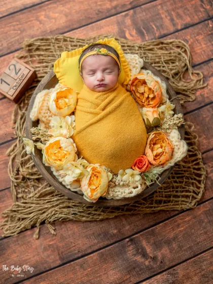 This wider shot of the yellow bowl setup includes a date block, a great way to commemorate your baby's birth date in the photos.