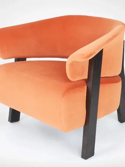This is a furniture shoot focusing on an orange velvet armchair. I used studio lighting to highlight the texture of the fabric and the clean lines of the wooden frame from a three-quarter angle.