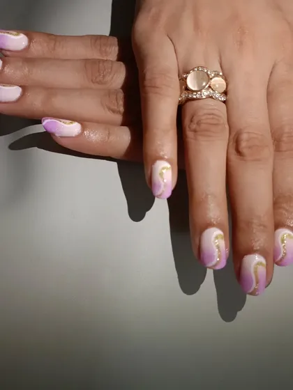 A different angle of the lavender ombre nails, showing how the gold swirls catch the light.