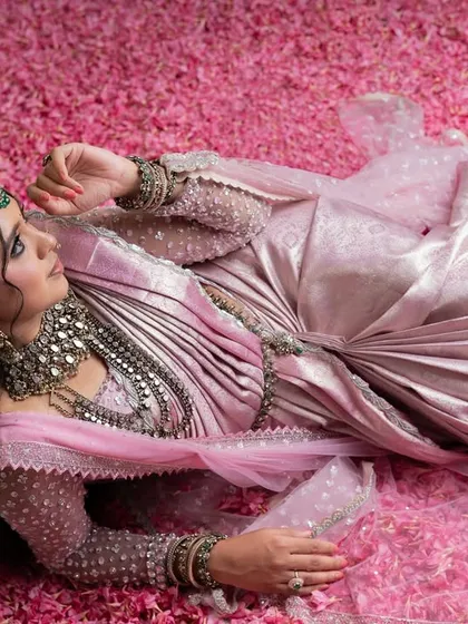 From my Maharani Series, this light pink Kanjivaram saree is where tradition meets modern artistry. I've adorned it with intricate zardozi and paired it with a net handwork blouse and a regal dupatta, a tribute to the ancient queens of India.