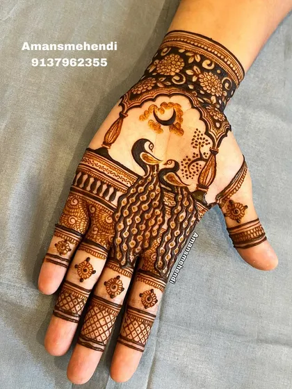 The companion hand to the Teej portrait, featuring two peacocks under a crescent moon, framed by an ornate arch.