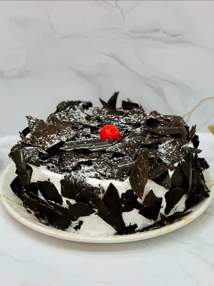 The classic Black Forest cake, done right. I use layers of chocolate sponge, fresh whipped cream, and cherries, and cover it all in generous chocolate shavings. It's a nostalgic favorite that I bake fresh daily.