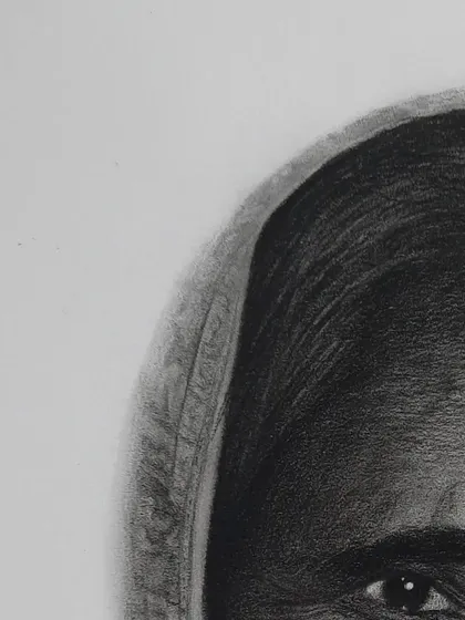 A close-up detail of my grandmother's portrait, focusing on the texture of her skin and the intricate pattern on her saree.