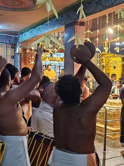 The view from behind the ensemble, capturing the devotion and energy directed towards the deity during a temple performance.
